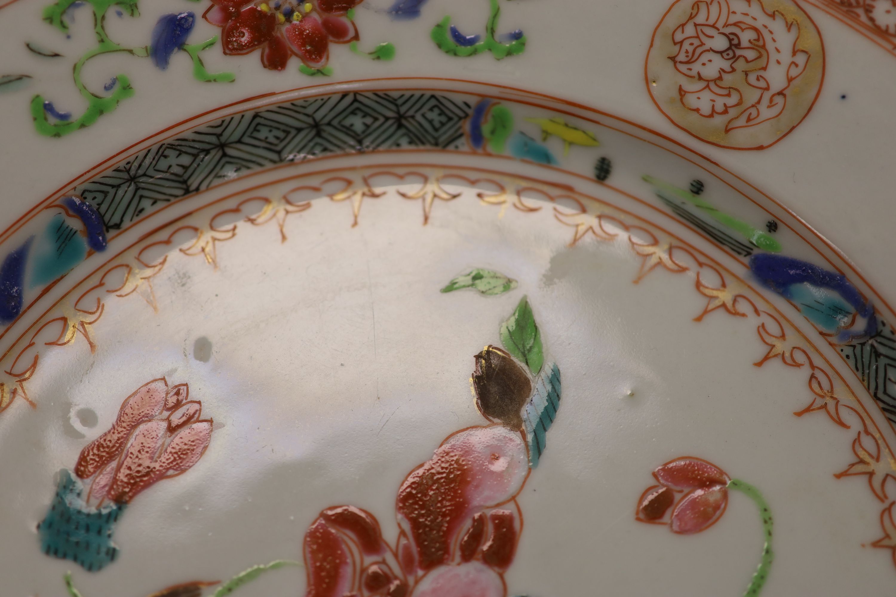 A pair of 18th century Chinese famille rose plates and another similar, largest diameter 22.5cm (damage)
